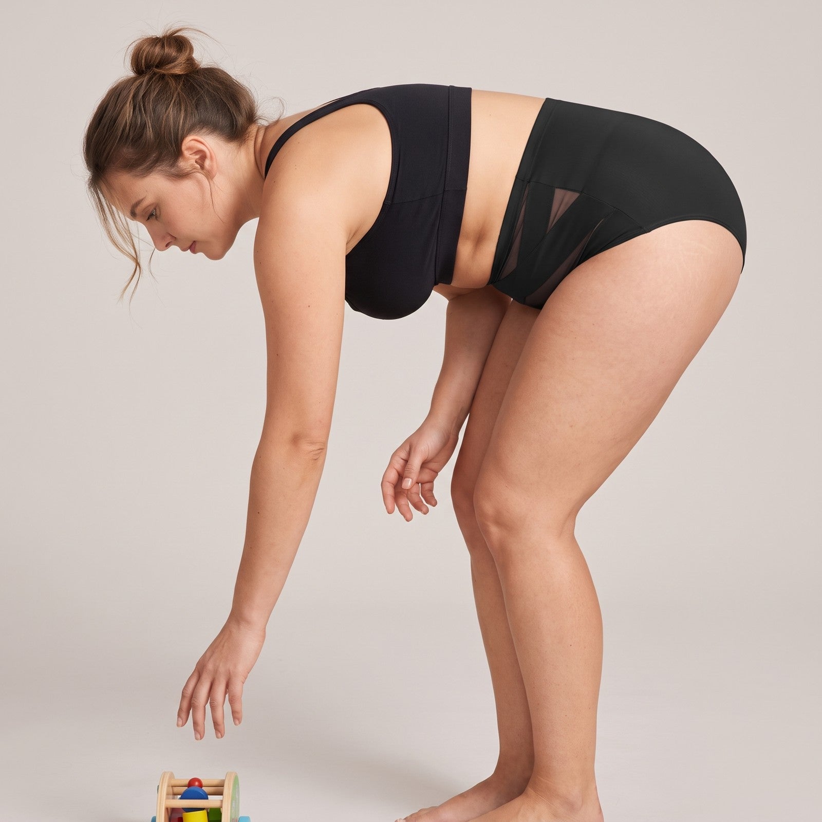 Woman bending over, waistband staying up